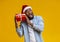 Crazy black guy in Santa hat holding Christmas gift box