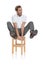 Crazy casual man sitting and holds legs in the air