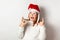 Crazy Christmas party, girl in New Year`s holiday clothes shows rock and roll isolated on a white background