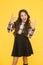 Crazy cool. Cool child show horns sign. Little girl with cool look yellow background. School fashion. Back to school