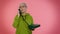 Crazy elderly granny old woman talking on wired vintage telephone of 80s, fooling making silly faces
