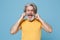 Crazy elderly gray-haired mustache bearded man in yellow t-shirt isolated on blue background. People lifestyle concept