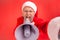 Crazy elderly man with gray beard wearing santa claus costume screaming at megaphone, protesting while livestreaming, wants to be