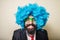 Crazy funny bearded man with blue wig