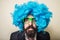 Crazy funny bearded man with blue wig