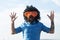 Crazy funny bearded man with wig and fun glasses on sky background. Funny facial expressions.