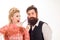 Crazy hairdresser blonde girl grooming handsome bearded man. Hipster man with beard and barber woman. Pretty glamour