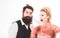 Crazy hairdresser blonde girl grooming handsome bearded man. Hipster man with beard and barber woman. Pretty glamour