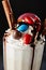 Crazy Milkshake or Freakshake with Chocolate Treats, Macaroons and Colorful Sweets Mix in Tall Glass Served