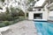 Crazy paving beside swimming pool in mid century modern home