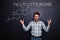 Crazy professor of chemistry standing and shouting over chalkboard background