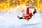 crazy santa claus flying on his sleigh snow golden bokeh background
