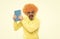 Crazy schoolmaster in orange wig with funky sunglasses shout loud holding library book, school