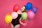 Crazy screaming young woman pozing with colorful balloons