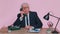 Crazy senior businessman talking on wired vintage telephone, fooling, making silly humor comic faces