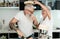 Crazy senior couple cooking together at home - Joyful elderly lifestyle and food nutrition concept - Main focus on man face