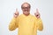 Crazy senior man in funny glassespointing index finger up