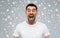 Crazy shouting man in t-shirt over snow background