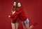 Crazy sisters best friends twins in fashion cozy winter sweater in studio