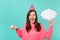 Crazy woman in birthday hat screaming, holding cake with candle, empty blank Say cloud, speech bubble for promotional