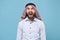 Crazy young bearded arabian muslim man in keffiyeh kafiya ring igal agal casual clothes  on pastel blue