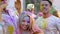 Crazy young people dancing and having fun at Holi festival, cool open-air party