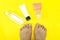 Cream bottles and feet fingers isolated yellow background. pedicure beauty concept