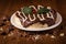 Cream cake with biscuit and chocolate syrup on the wooden background. In Brazil it is called Torta alem