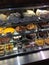 Cream cakes pies tarts chocolate flans on display shelves