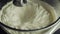Cream cheese being mixed in a food processor