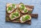 Cream cheese, green peas, radishes and micro greens spring sandwiches on a cutting board. Healthy eating, slimming, diet lifestyle