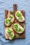 Cream cheese, green peas, radishes and micro greens spring sandwiches on a cutting board. Healthy eating, slimming, diet lifestyle