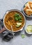 Cream coconut lentil curry and naan bread - healthy vegetarian food. On a grey background