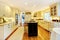 Cream color kitchen with large white sink and classic design.