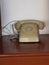 Cream color rotary telephone rings with handset off