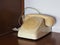 Cream color rotary telephone rings with handset off