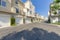 Cream colored townhouses with attached garage asphalt driveway