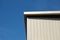 Cream corrugated facade against blue sky