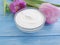 Cream cosmetic flower tulip cleanser products moisturizer beauty wooden background