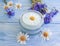 Cream cosmetic flowers cornflower, treatment product camomile on a wooden background