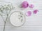 cream cosmetic gypsophila rose flower on wooden background extract hydration