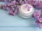 Cream cosmetic lilac aromatic table therapy on a wooden background treatment