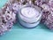 Cream cosmetic lilac on blue wooden health relax bottle homemade