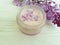 Cream cosmetic lilac flower moisturizer aromatic treatment on white wooden anti aging homemade harmony spa