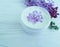 Cream cosmetic lilac on white wooden homemade harmony spa