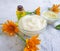 Cream cosmetic moisturizing oil flower calendula healthy relaxation accessories handmade on concrete background