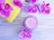 Cream cosmetic orchid flower cleanser spring beautiful treatment on wooden background