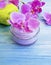 Cream cosmetic orchid flower spring beautiful treatment on wooden background