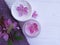 Cream cosmetic relaxation spa pink flowers organic on white wooden towel