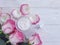 Cream cosmetic rose flower on wooden background handmade